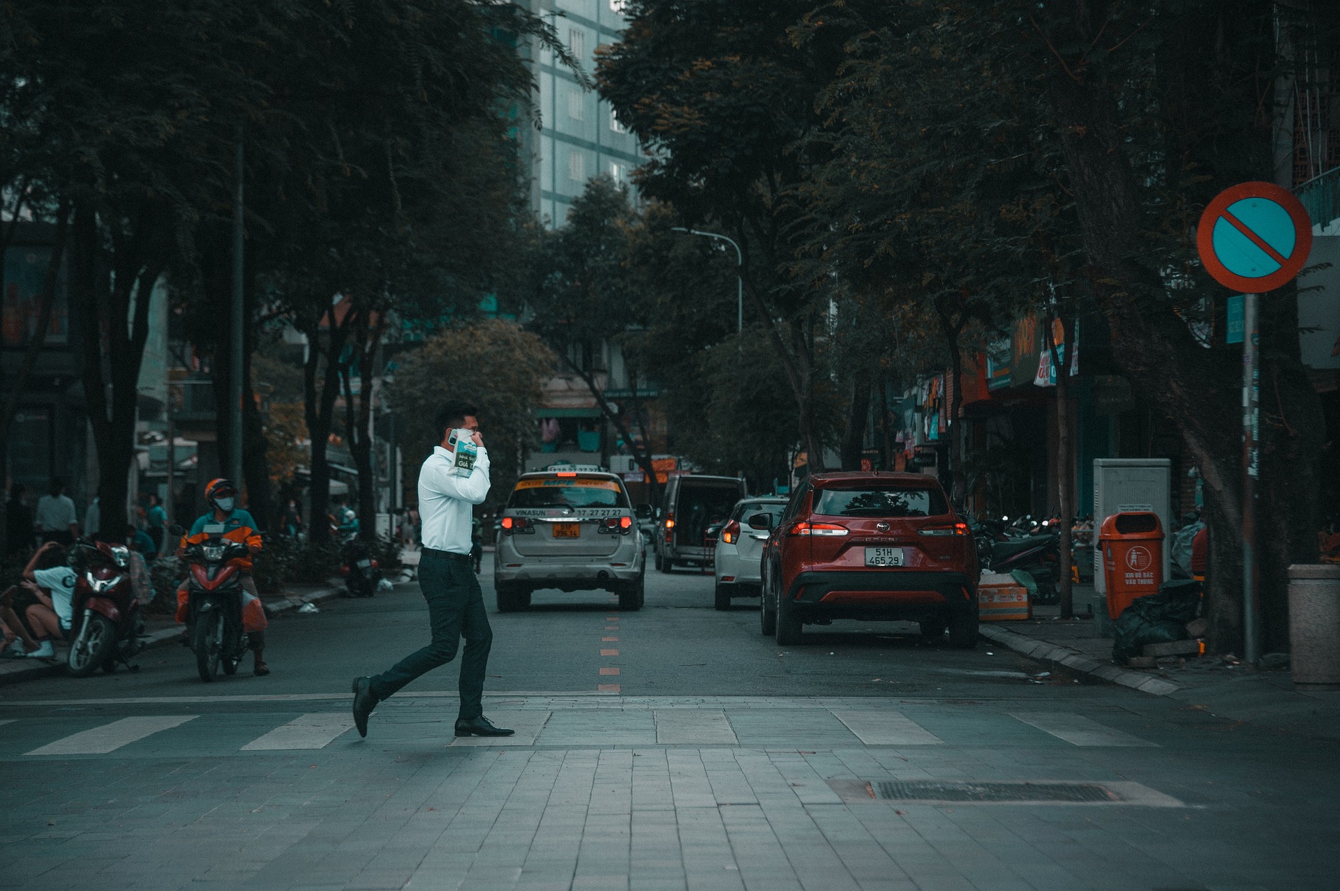 Man is on a phone walking over a street